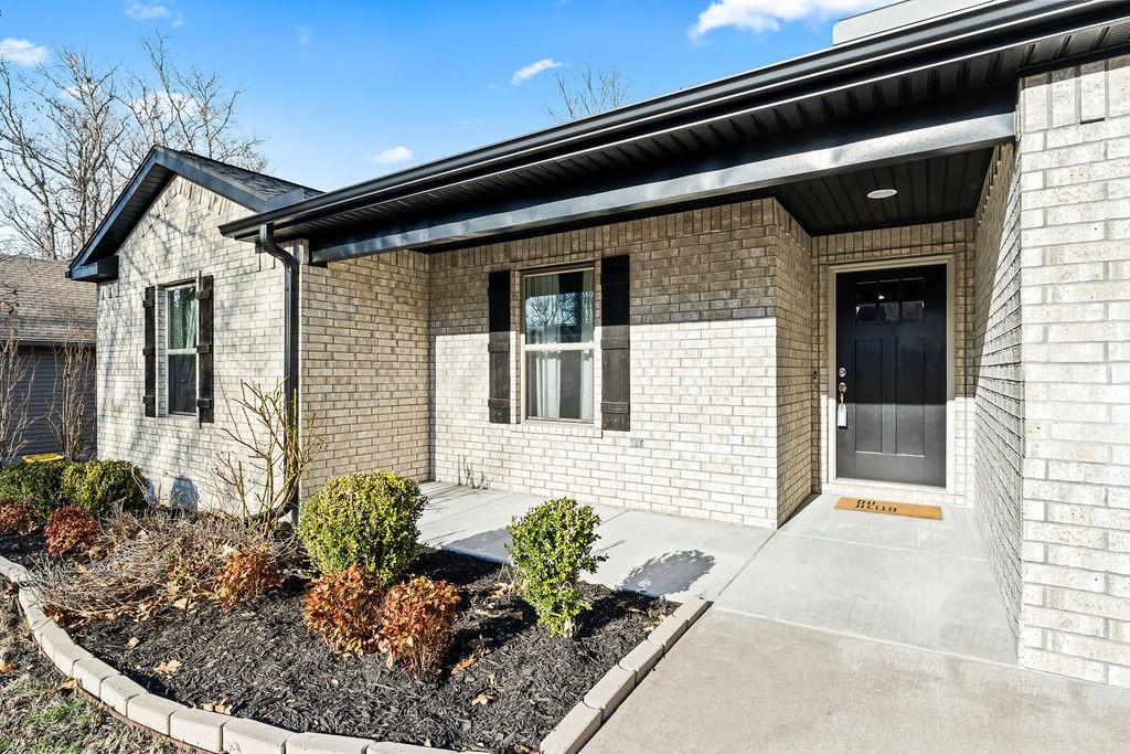 Image 4: Entrance to property featuring covered porch and b