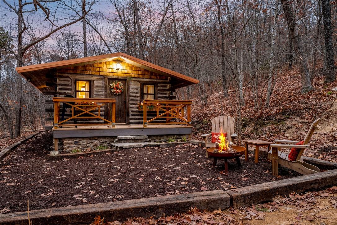 Image 2: Outdoor structure at dusk with an outdoor fire pit