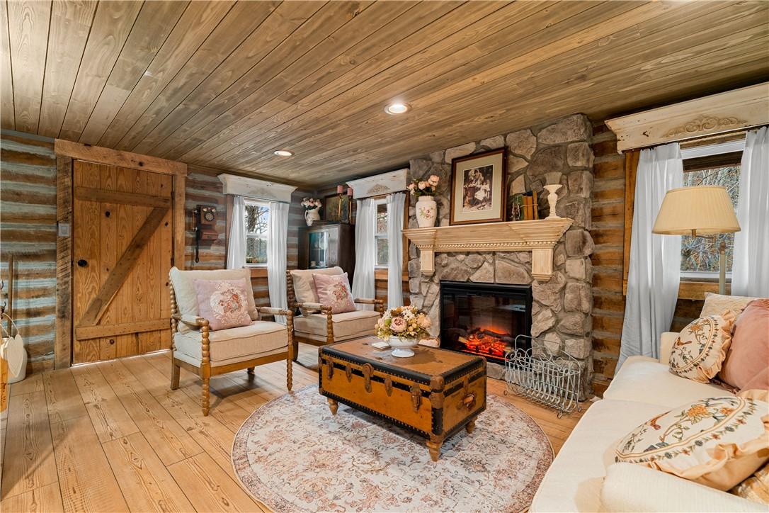Image 3: Living area with wood ceiling, a fireplace, wood-t