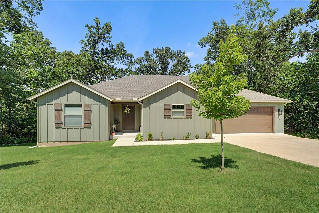 Image 1: Single-story exterior featuring sage green vertica