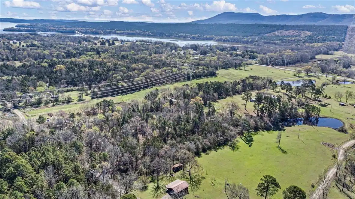 Image 1: Expansive aerial property featuring verdant fields