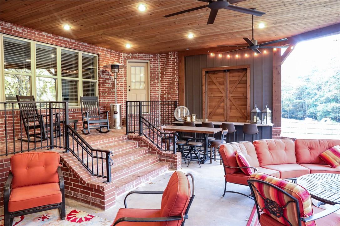 Image 2: Covered back porch w/ fireplace