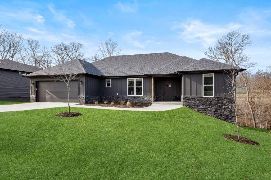 Image 2: Ranch-style home with stone siding, a front lawn,