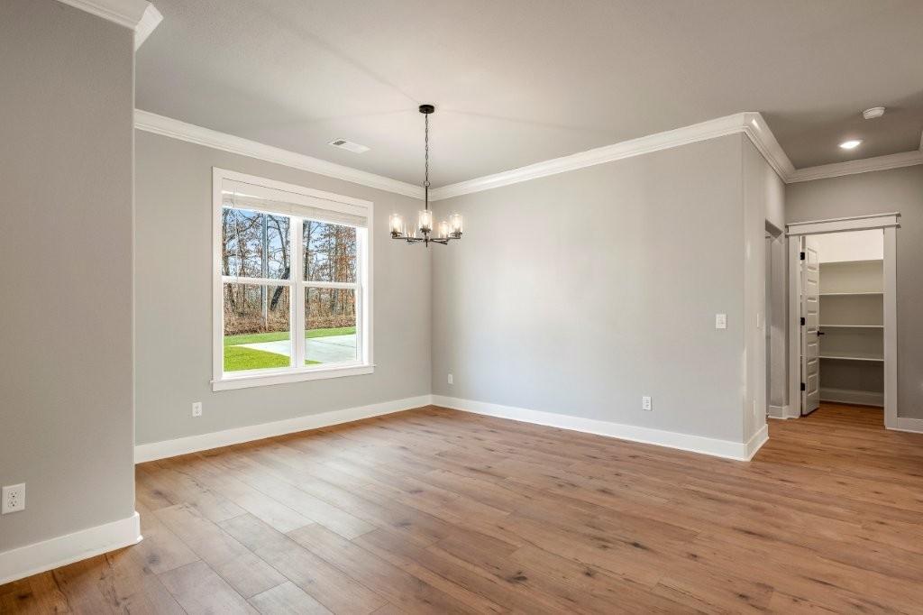 Image 4: Unfurnished dining area with a chandelier, ornamen