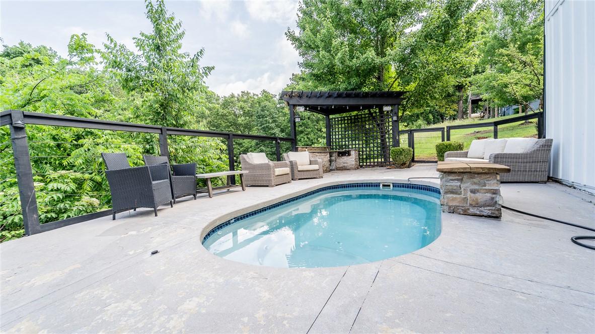 Image 3: View of pool featuring an outdoor living space, pa
