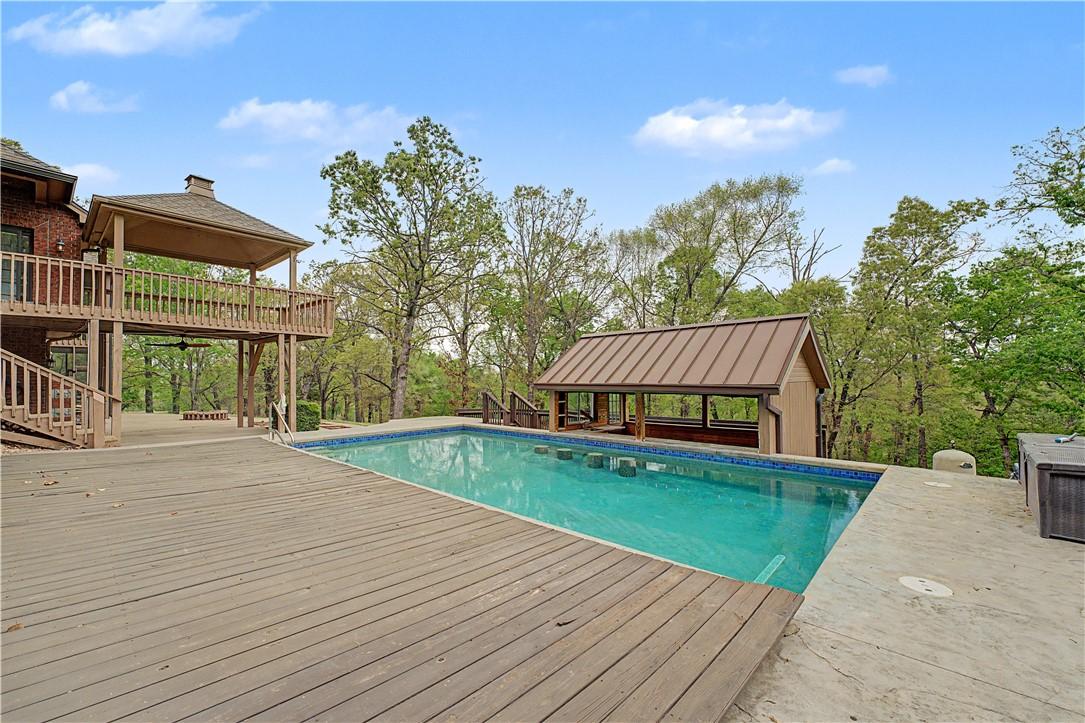 Image 4: The property features a heated in-ground pool, dec