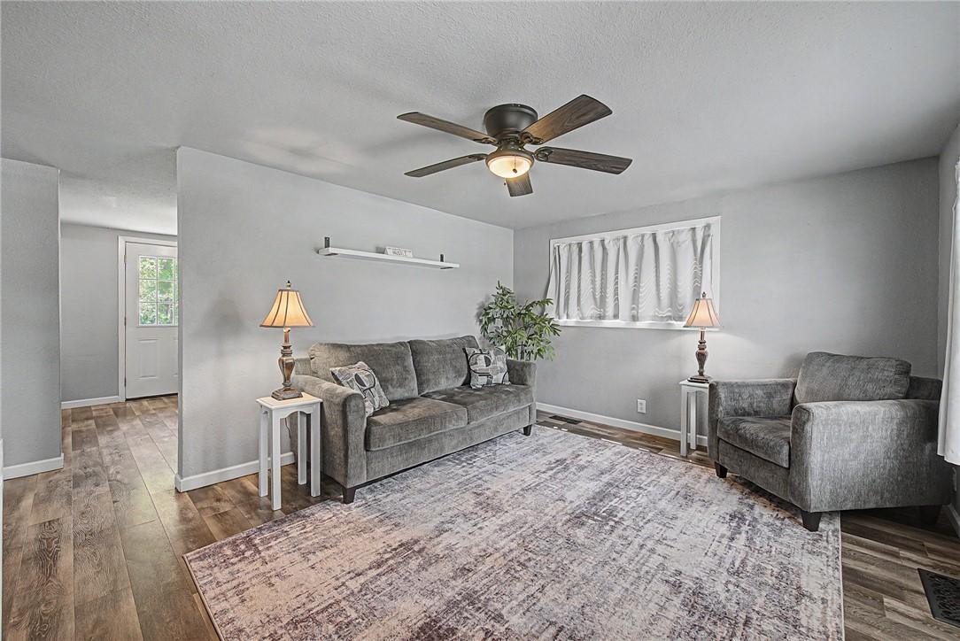 Image 3: Living area featuring wood-finish flooring, light