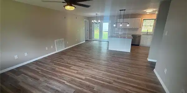 Image 2: Open-concept living space featuring wood-finish fl