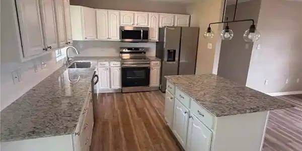 Image 3: Kitchen featuring white cabinetry, granite counter