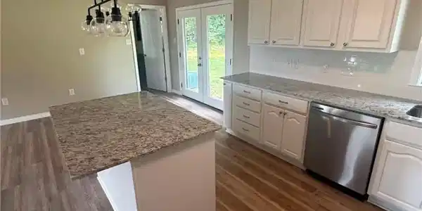 Image 4: Kitchen featuring wood-finish flooring, white cabi
