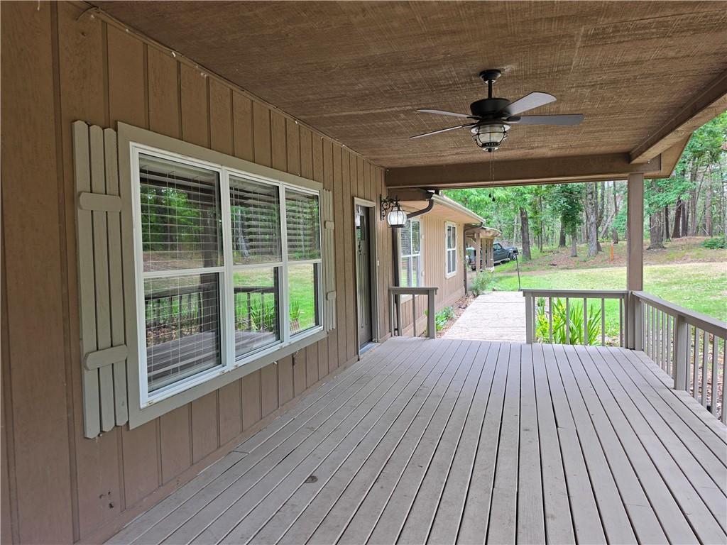 Image 4: Spacious covered porch featuring wood-finish decki