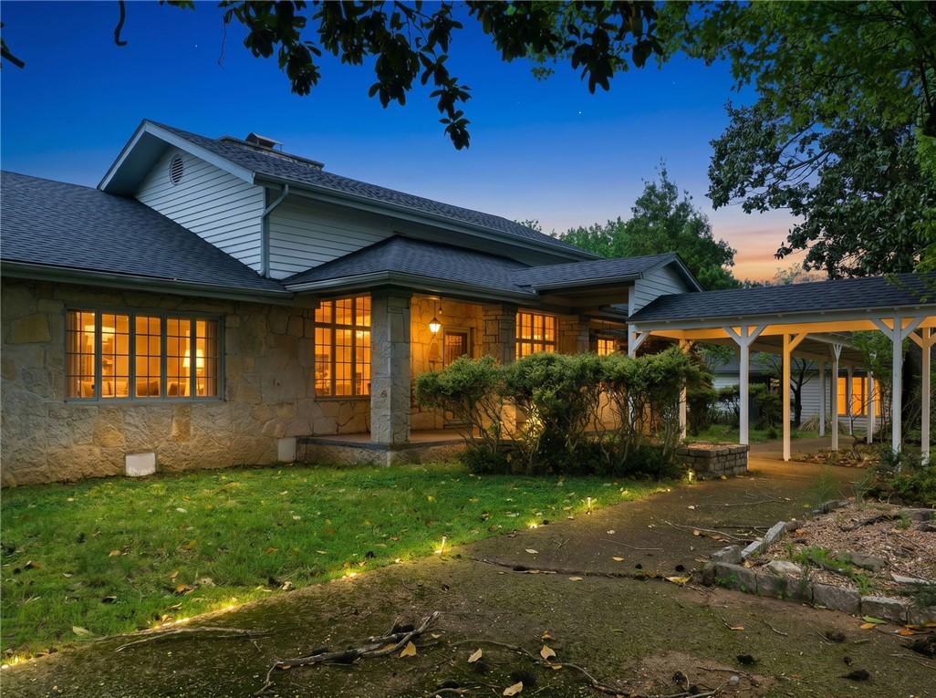 Image 3: Stone and siding exterior featuring a covered entr