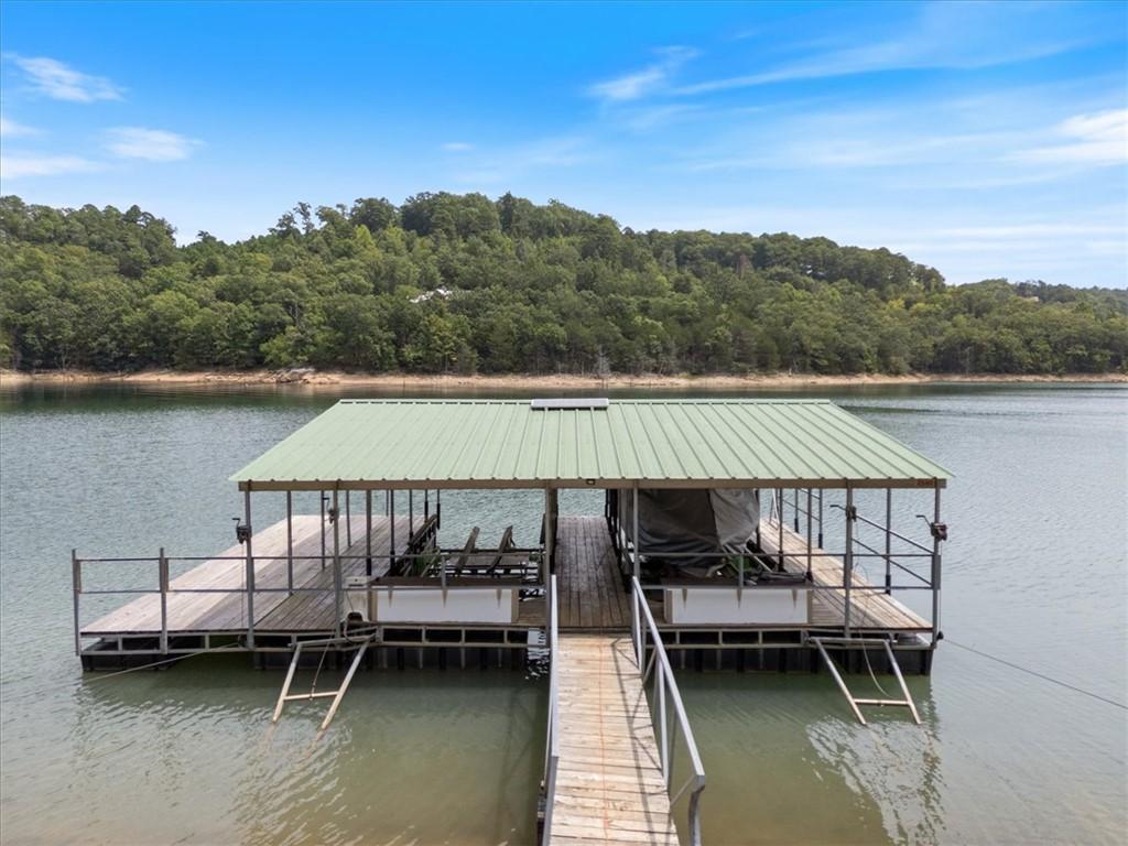 Image 2: Covered boat dock with two boat slips, a wood-fini