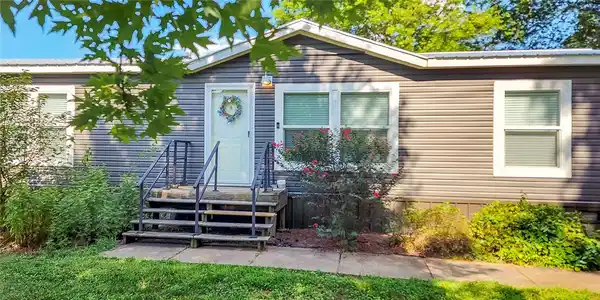 Image 3: Gray horizontal siding exterior with a white entry