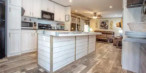 Image 4: Kitchen featuring an island with shiplap-style pan
