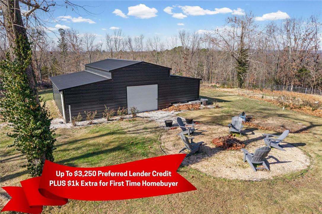 Image 3: View of outbuilding featuring an outdoor fire pit
