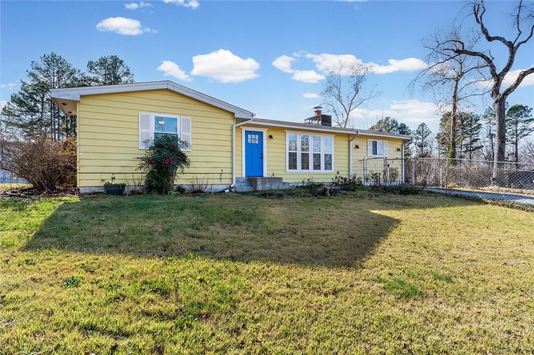 Image 4: View of front of home with a chimney