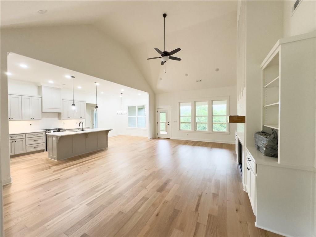Image 2: Living room with a ceiling fan, light wood finishe