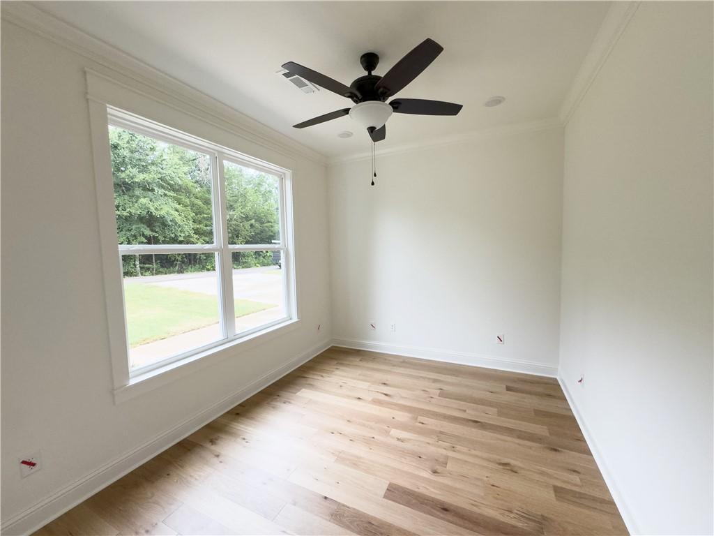 Image 3: Spare room featuring ornamental molding, light woo
