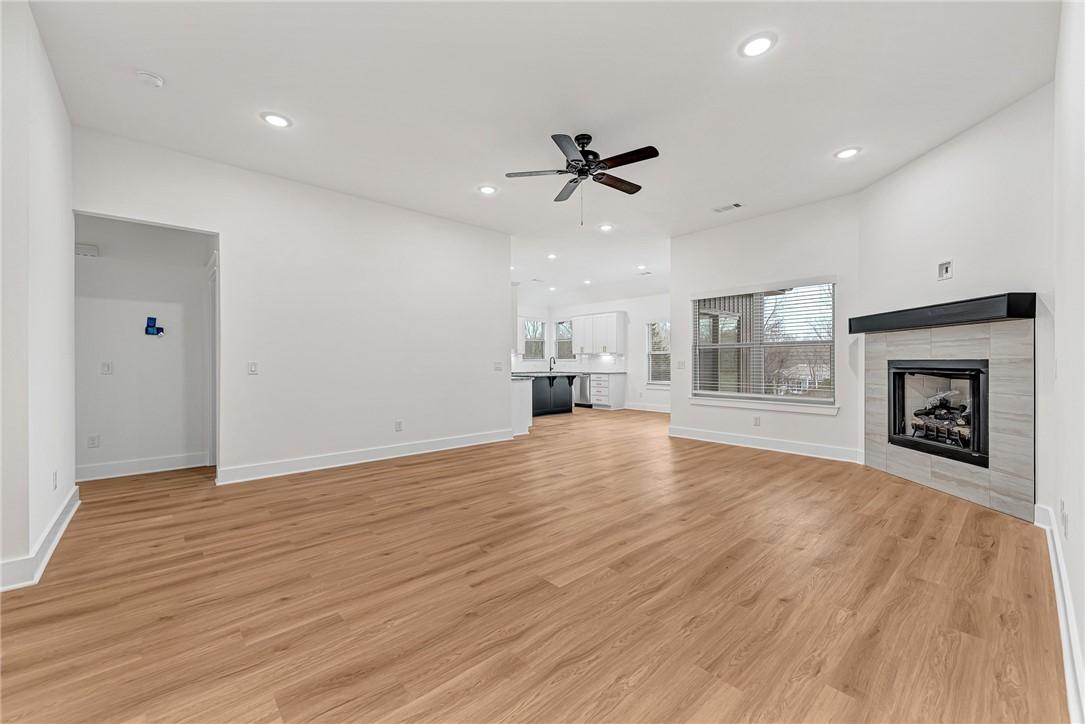 Image 4: Unfurnished living room with a tile fireplace, lig