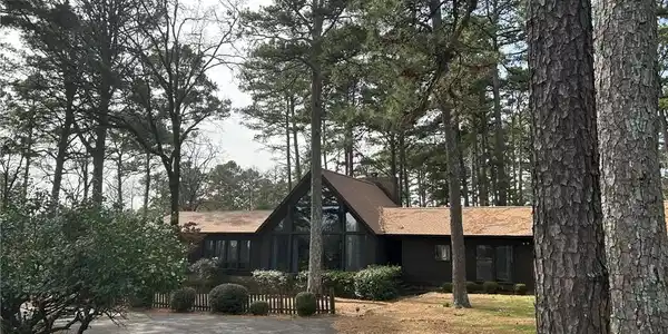 Image 2: View of front of house with asphalt driveway