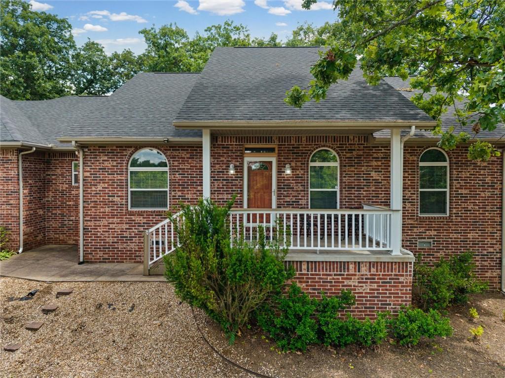 Image 4: Brick exterior with a covered front porch featurin