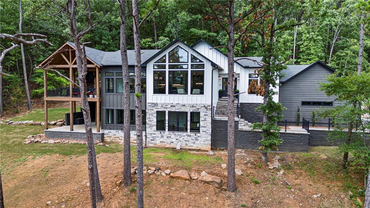 Image 4: Modern mountain-style residence featuring a promin