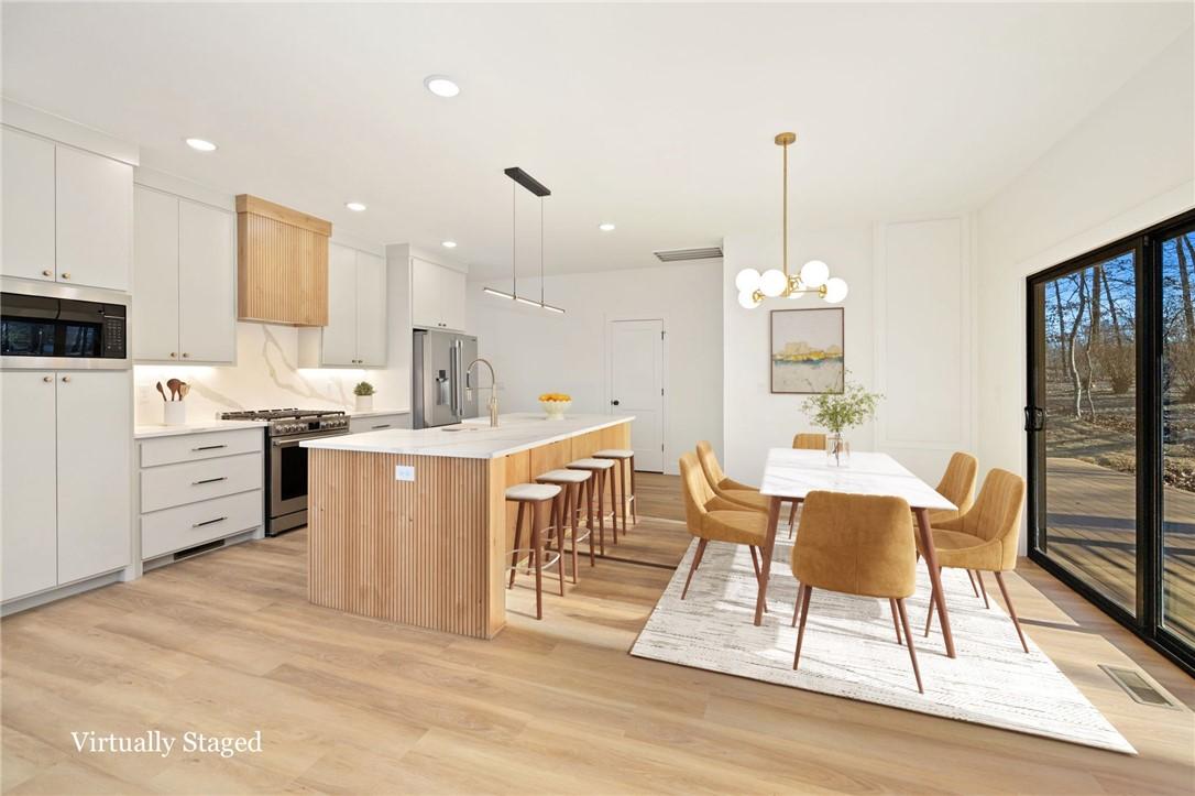 Image 3: Virtually staged kitchen and dining area.