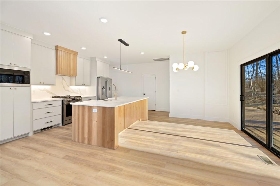 Image 4: Eat-in kitchen complete with large sliding doors a