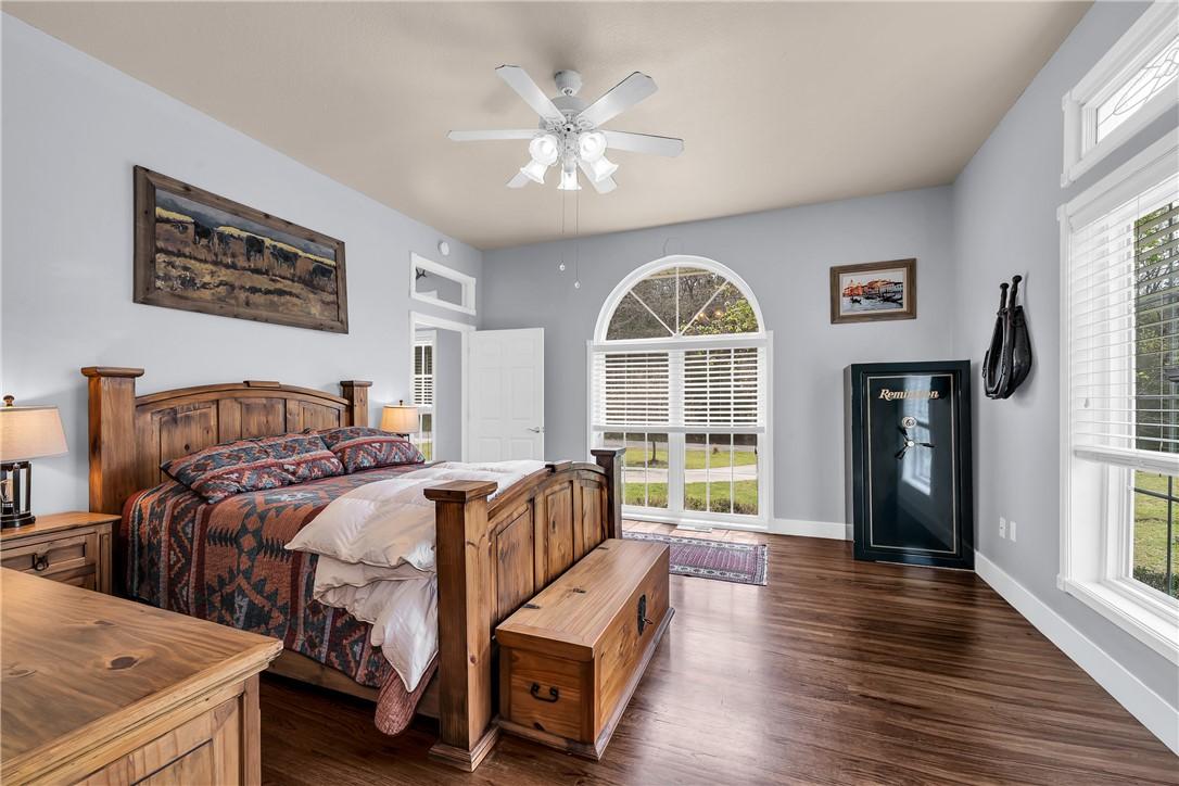 Image 4: The main floor primary bedroom shines with natural