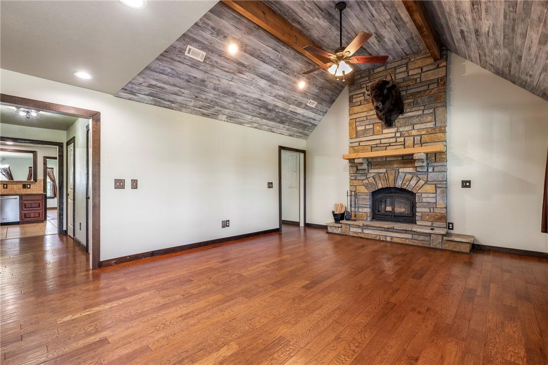 Image 4: Spacious interior featuring a stone fireplace with