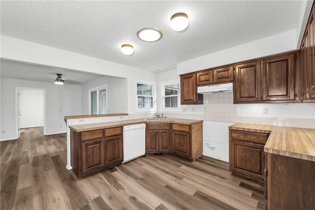 Image 3: Kitchen featuring wood-finish flooring, wood cabin