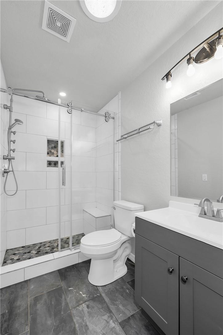 Image 4: Contemporary bathroom featuring a walk-in shower w