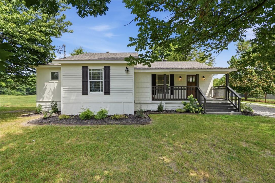 Image 1: Charming ranch-style home featuring a classic whit