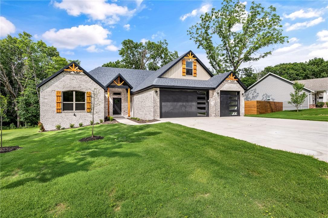 Image 2: Contemporary brick and siding exterior with dark g