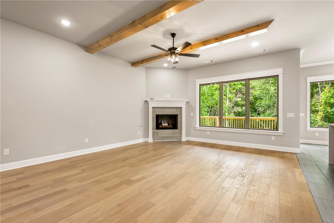 Image 4: Spacious living area featuring wood-finish floorin
