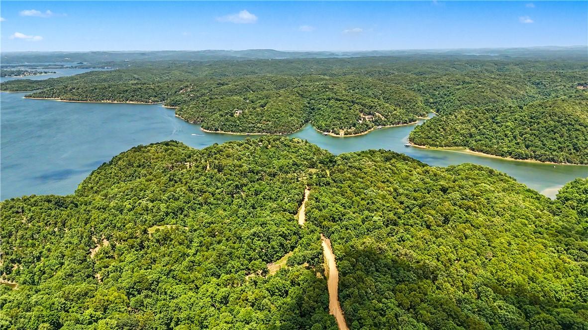 Image 4: Expansive water frontage with mature tree coverage