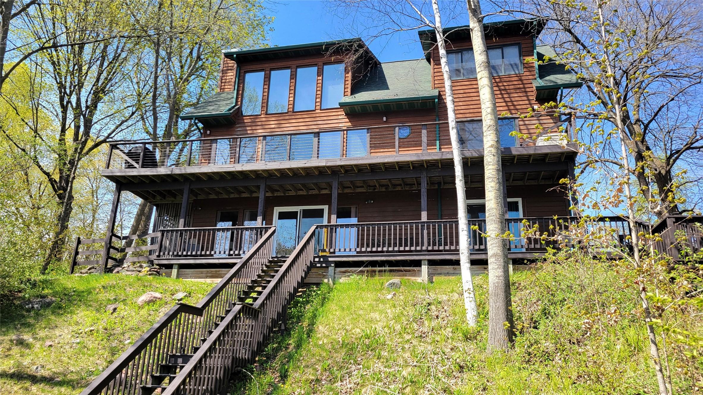 Image 1: Steps lead to level lakeshore and sandy frontage.