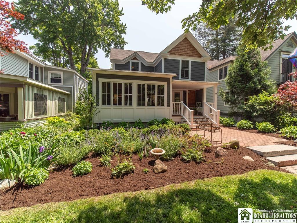 Image 2: Gorgeous gardens adorn the front of the home and f