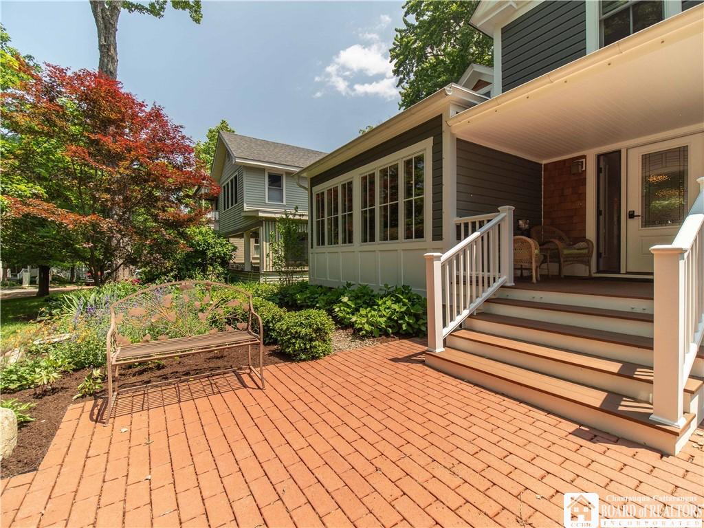 Image 3: The front patio leads to the way to the covered po