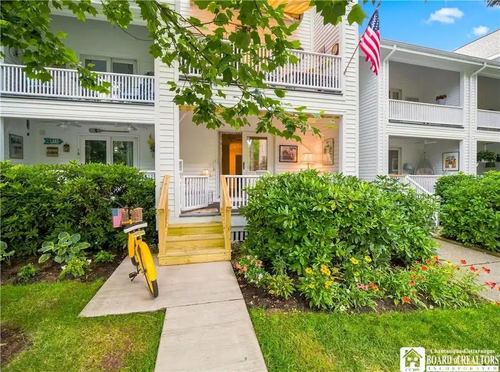 Image 1: Paved walkway leads to the porch entry to Unit 2 L