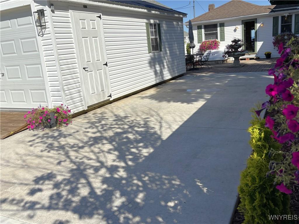 Image 1: View of garage/home from end of driveway