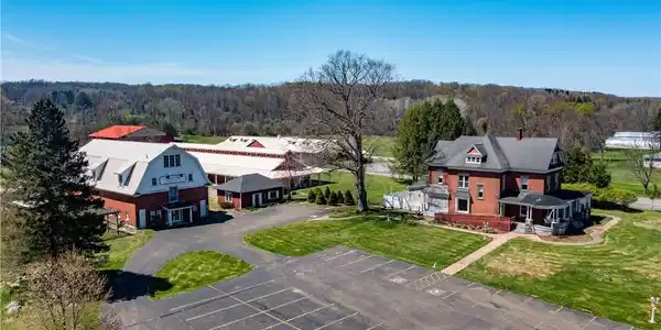 Image 2: Paved driveways with ample parking lead to the cen