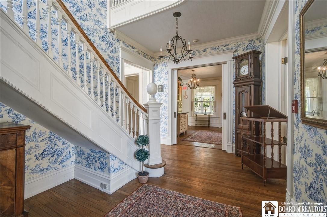 Image 4: Formal entryway with gorgeous original banister an