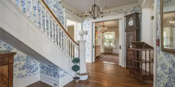 Image 4: Formal entryway with gorgeous original banister an