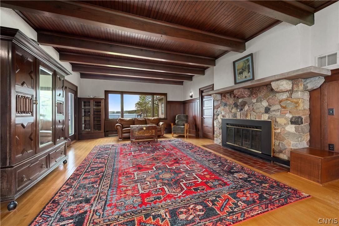 Image 3: Spacious living room with exposed wood beam ceilin