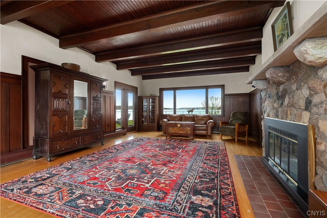 Image 4: Spacious living room with exposed wood beam ceilin