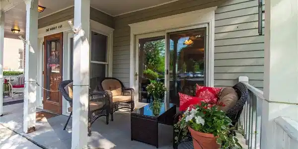 Image 4: The front porch has room for you to add more seati