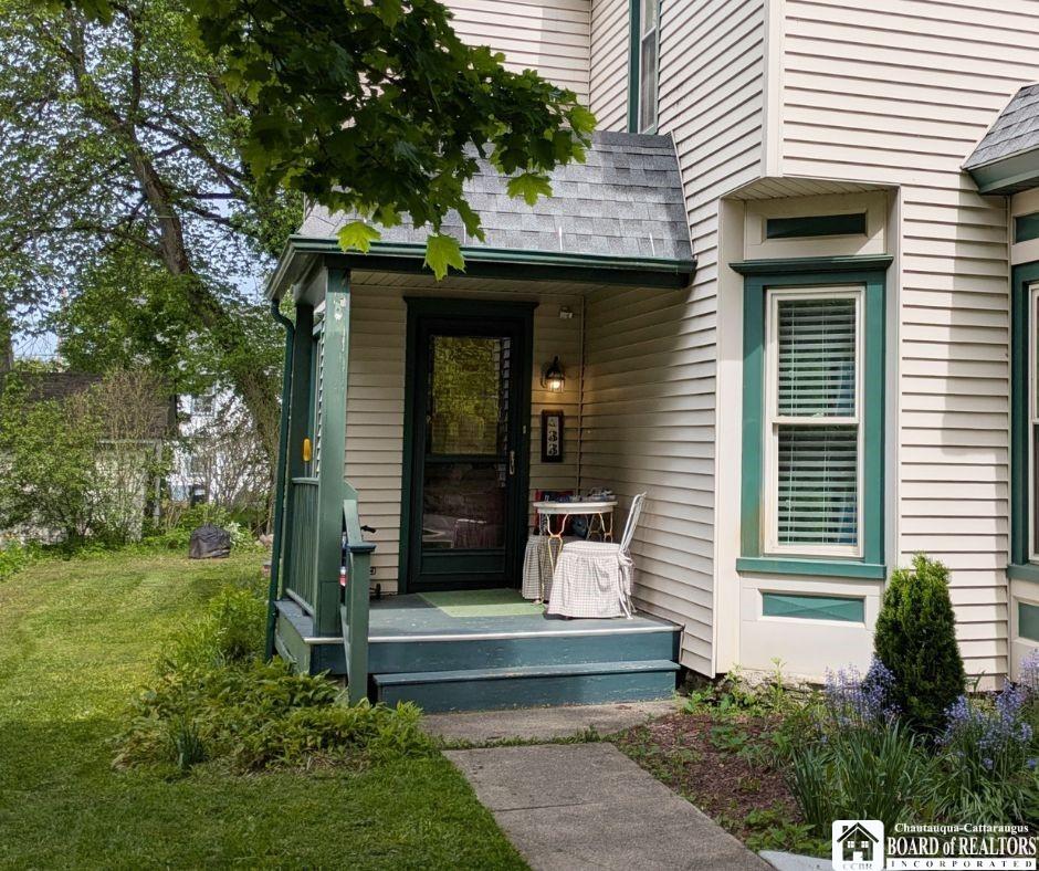Image 2: The covered front porch with room for a table and