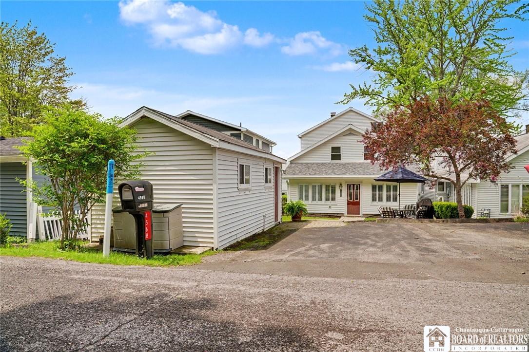 Image 2: Spacious driveway with detached Storage Building,